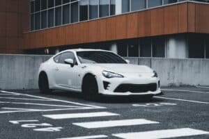 Stylish white Toyota GT86 parked in a urban setting showcasing modern design.