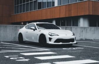 Stylish white Toyota GT86 parked in a urban setting showcasing modern design.